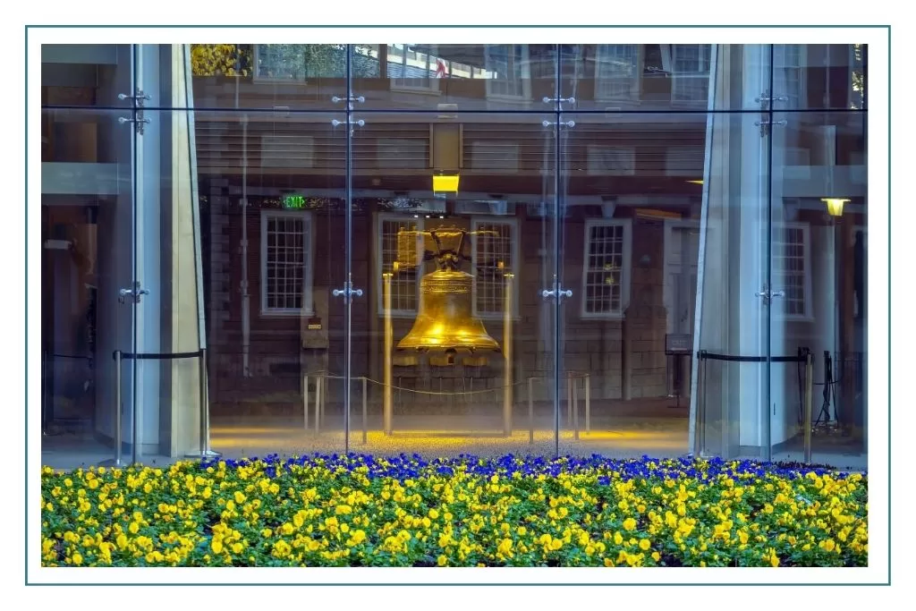 The Liberty Bell on display behind a window in Philadelphia