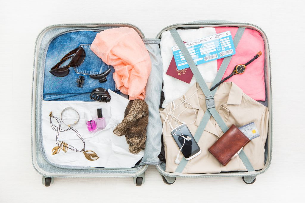 Open suitcase showing contents of clothing and other travel essentials