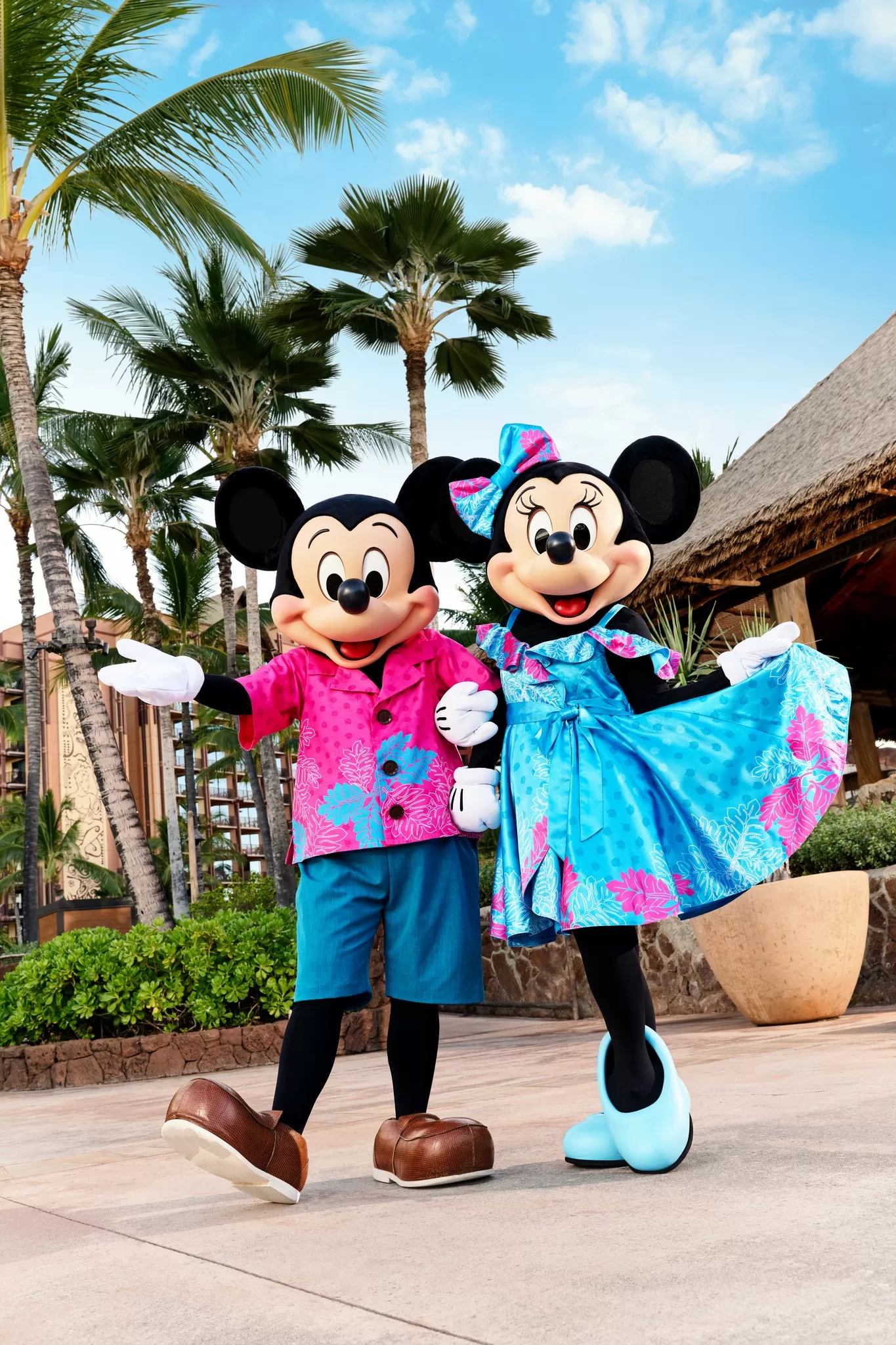 Mickey and Minnie Mouse wearing hawaiian themed clothing