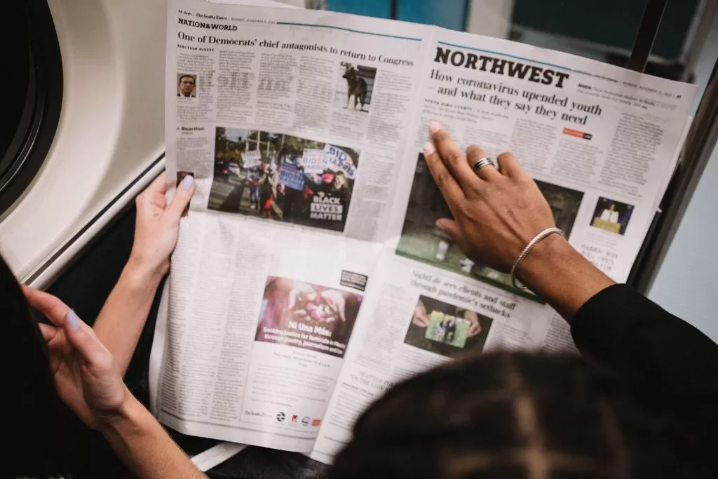 Two people reading a newspaper